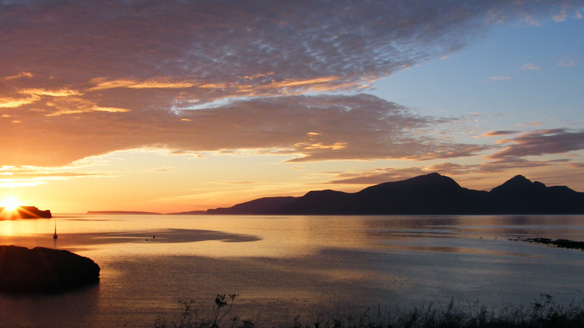 Sunset over Horse Island, Canna and Rùm. Photo: Chris Booth (CC BY-SA 2.0) 