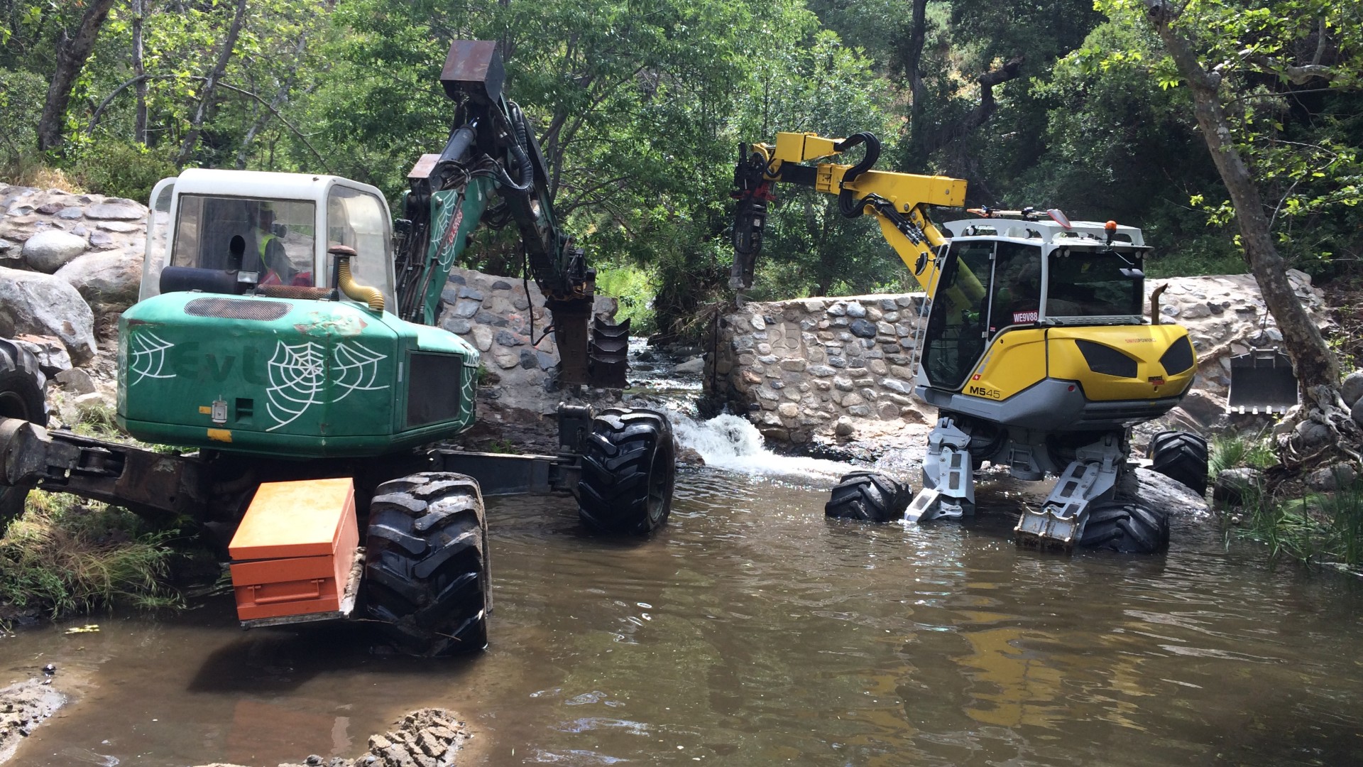 spider excavators removing dam