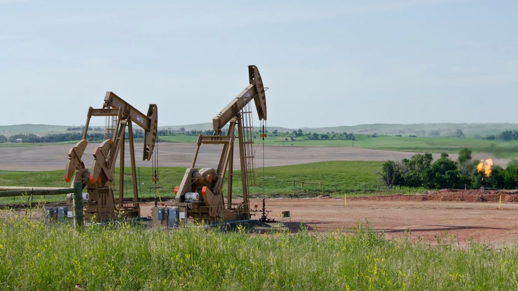 two pumpjacks with flare