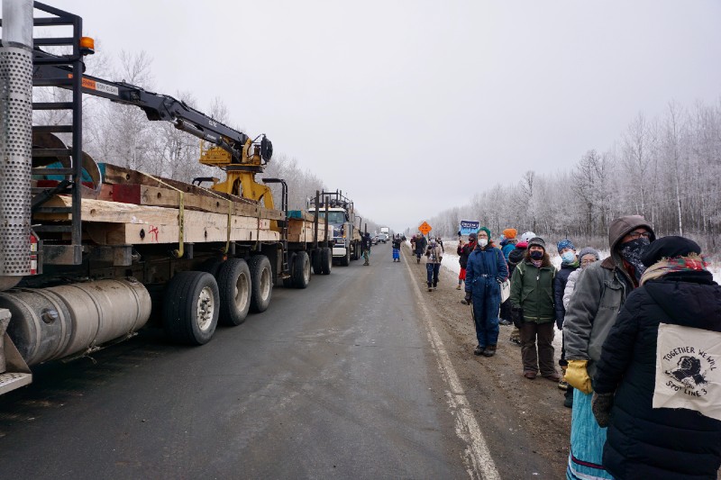 line of protesters and trucks