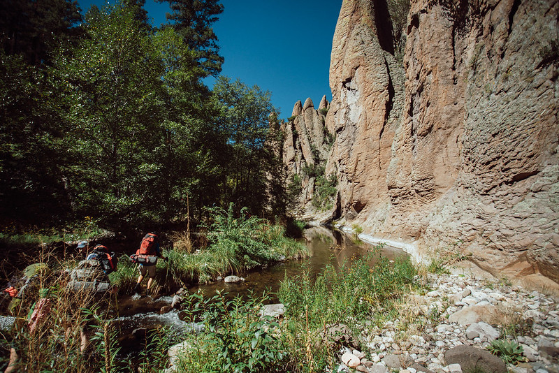 Backpackers crossing a stream 