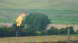 Gas flare and fields of hay