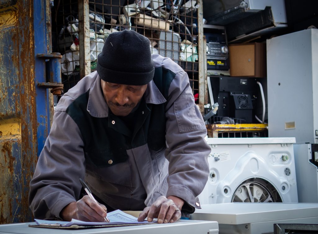 Man leaning over desk in shop