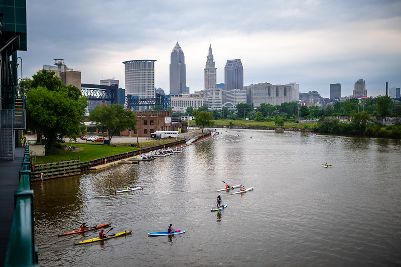 Kayakers on river with downtown buildings in the background
