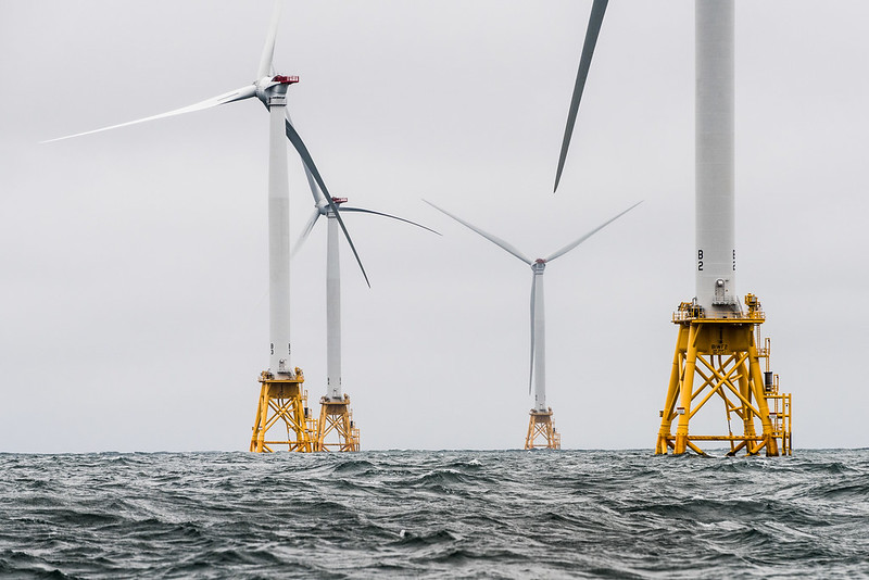 Close-up view of five offshore turbines in choppy water