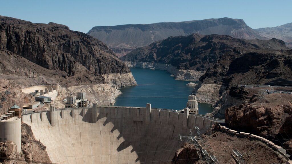 Top of hoover dam with lake mead behind it showing fallen water level
