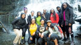 Group of 11 poses at waterfall.