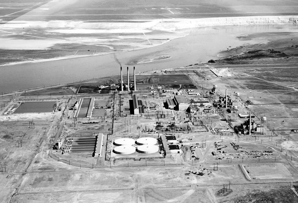 Black and white aerial view of site along river.