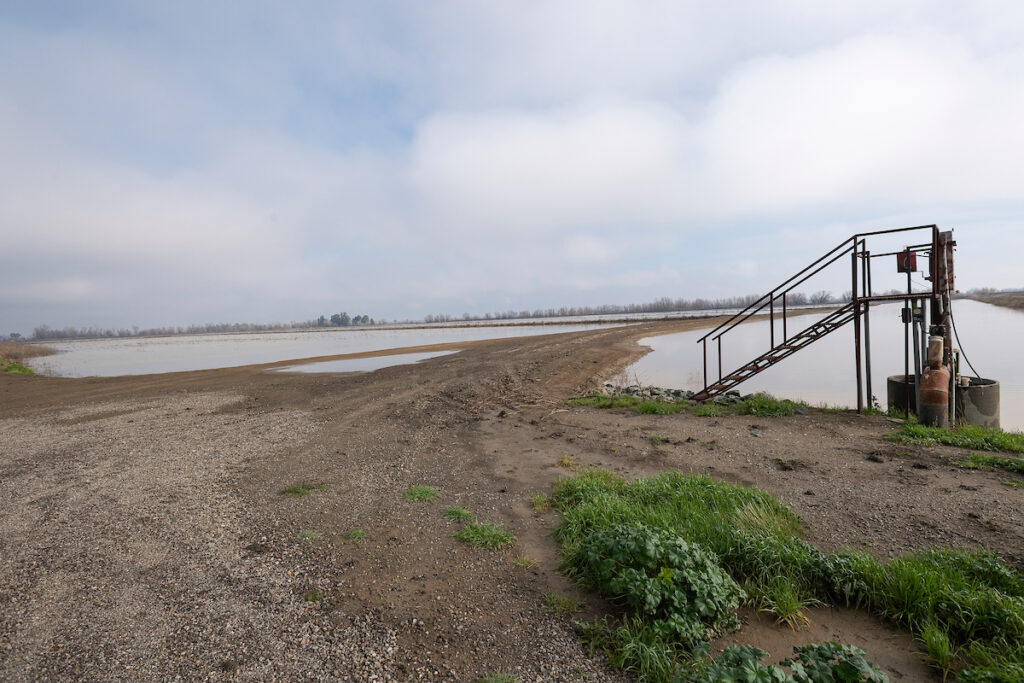 Exposed ground and water covering a field