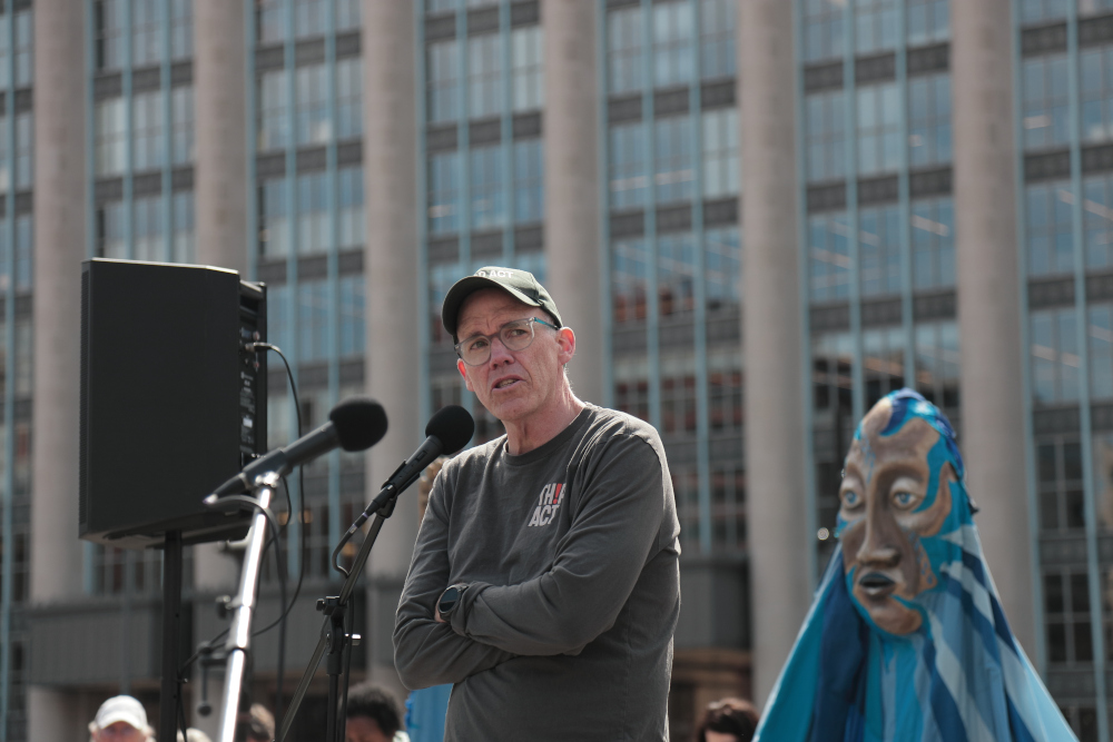 Bill McKibben stands at a microphone