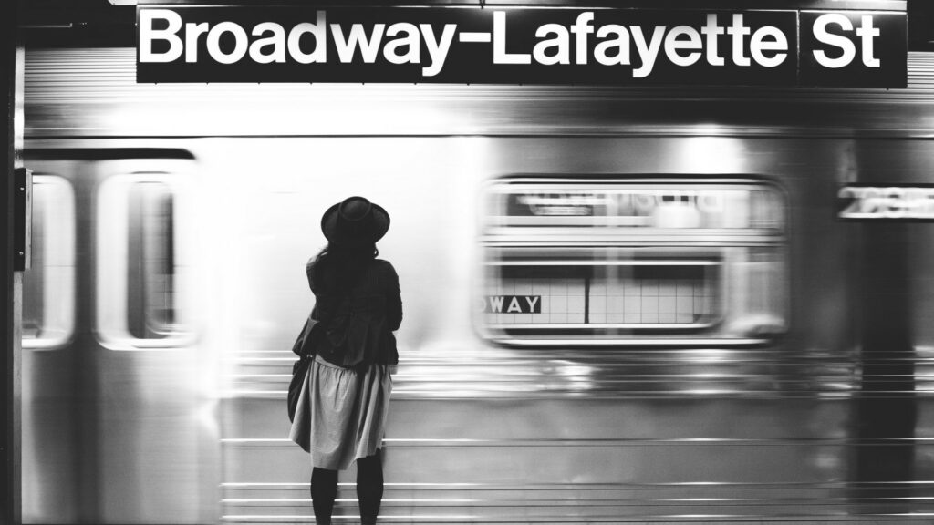 A woman stands on the Broadway Lafayette subway station as a train roared spy.
