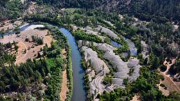 Aerial view of river with tailings piles