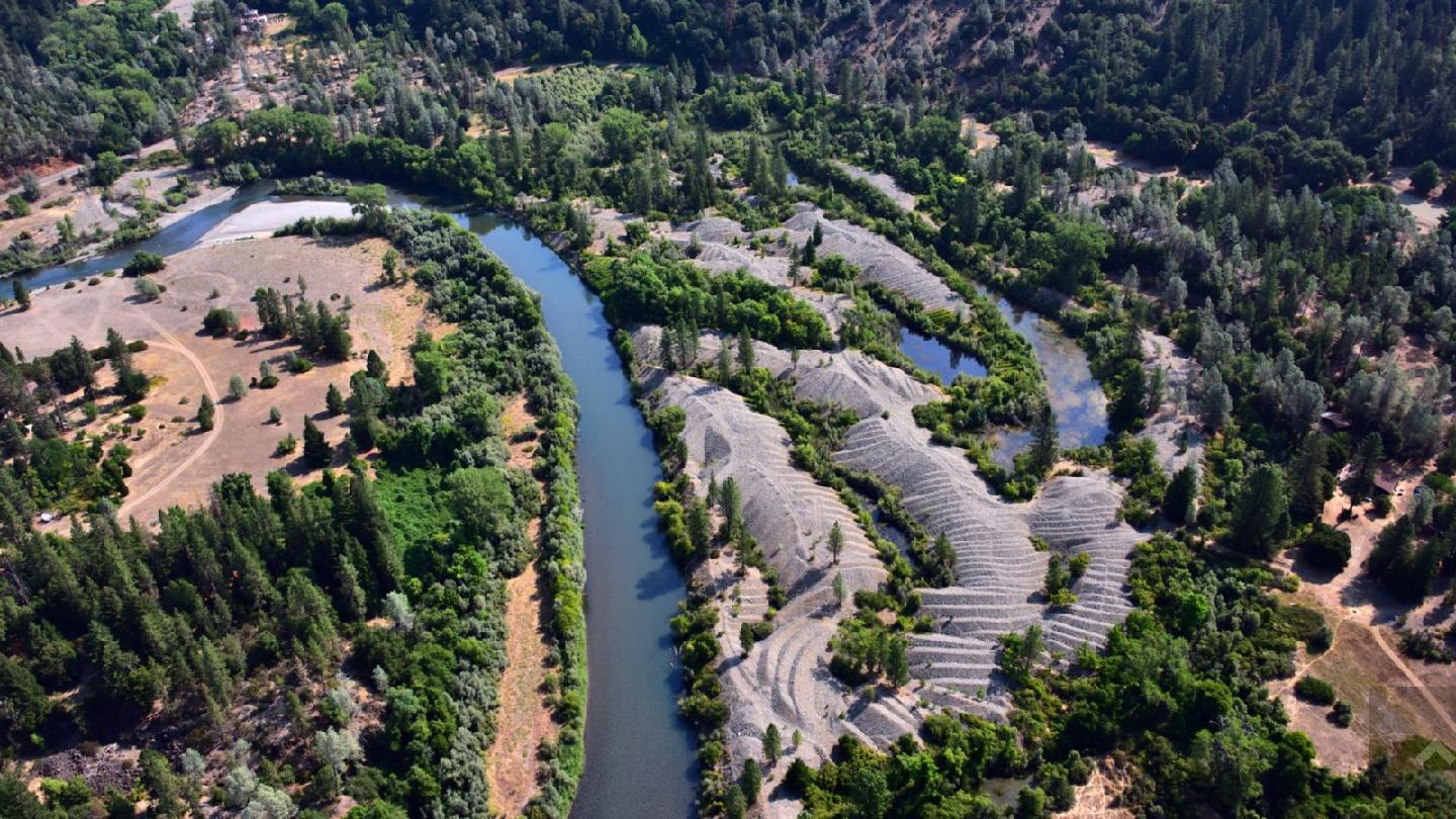 Aerial view of river with tailings piles