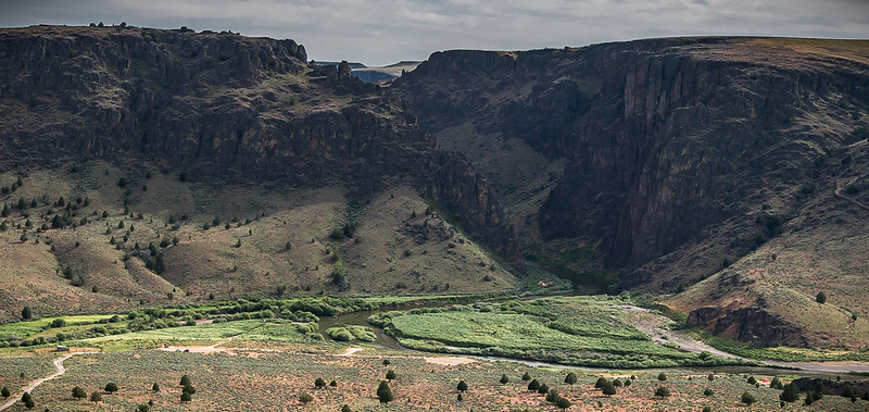 Canyon with green river valley