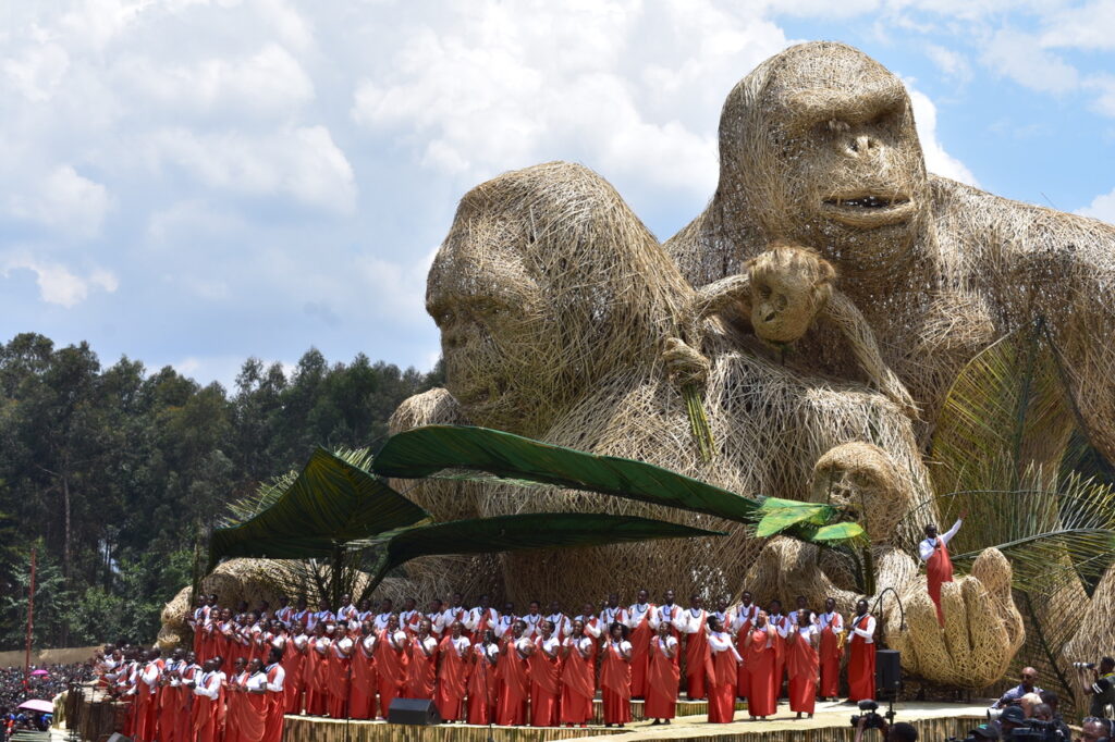 A chorus of singers in front of the gorilla statue