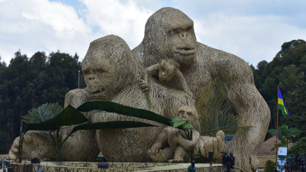 A wooden statue of a mountain gorilla family looms over the fairgrounds