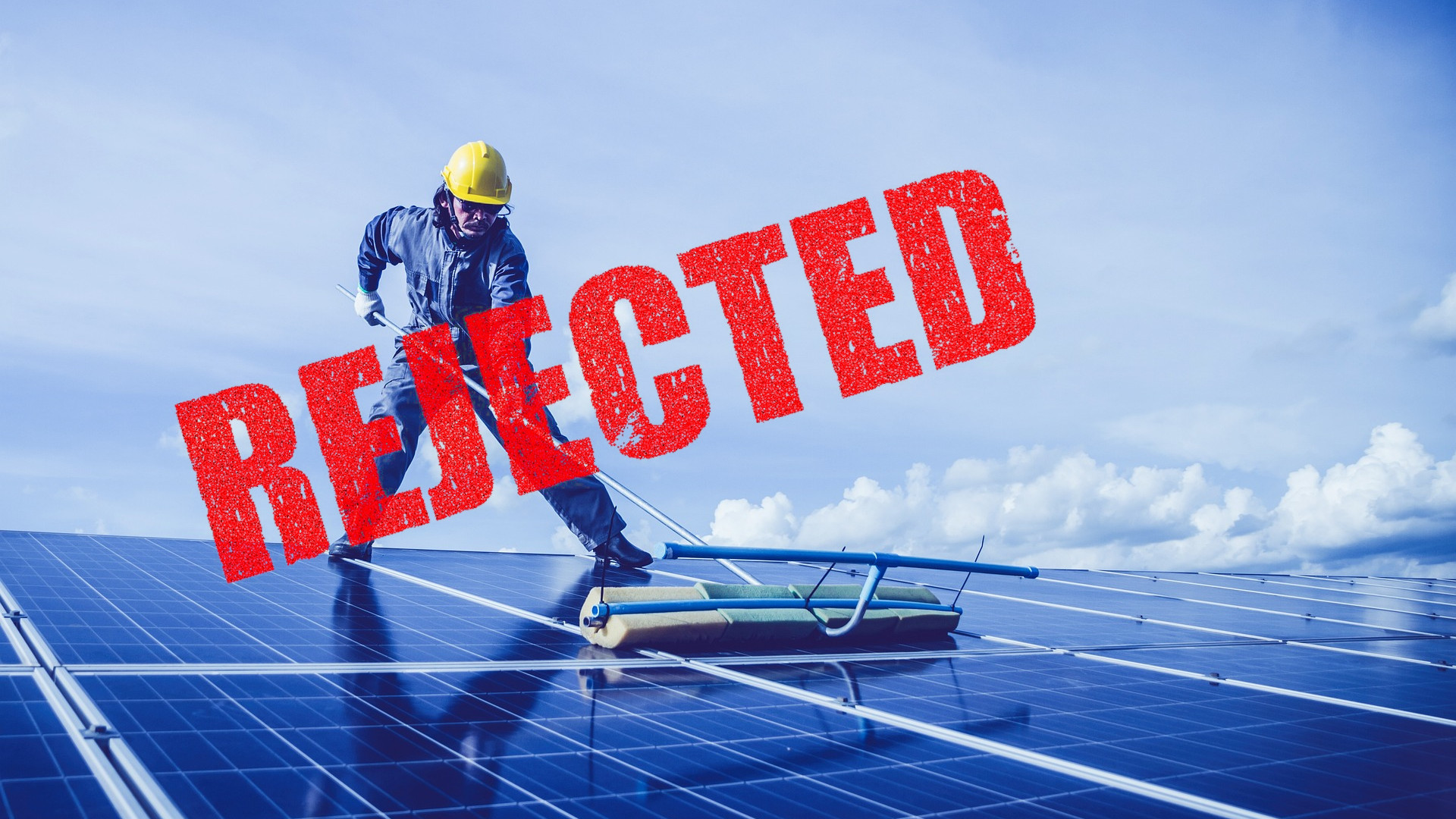 A man installing solar panels with the word "rejected" stamped over the photo