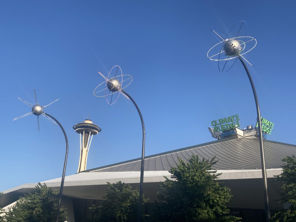 Climate Pledge arena with Space Needle in the background.