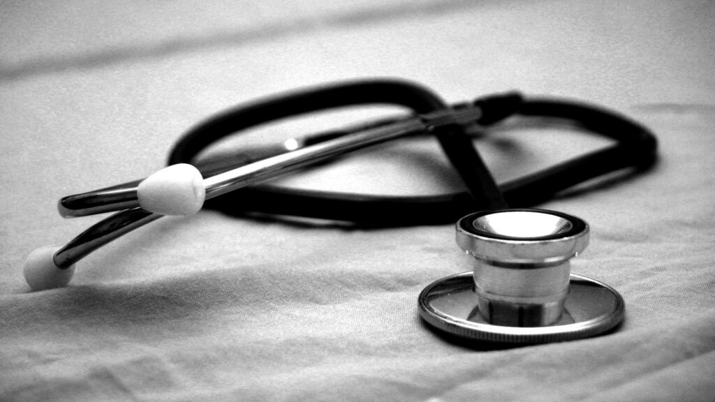 A black-and-white image of a stethoscope on a cloth