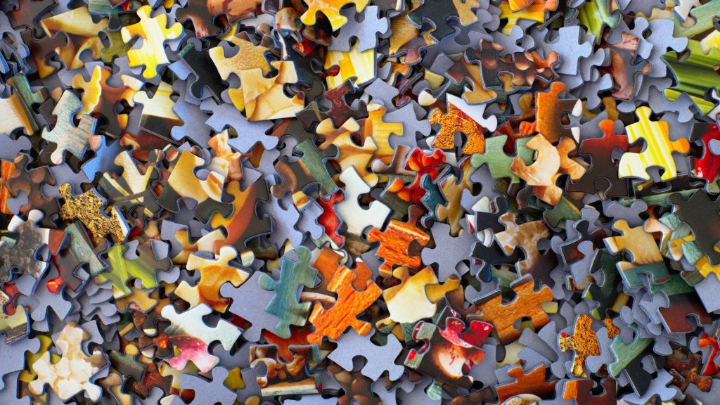 A pile of puzzle pieces waiting to be connected